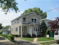 Light brown home with dormer